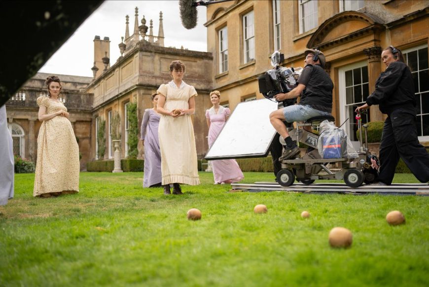 women in regency dressed being filmed